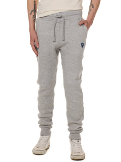Front view of a male model wearing the Men's summer night heather gray joggers. The joggers have a dyed to match drawstring and navy and white embroidered double diamond logo near the left pocket.