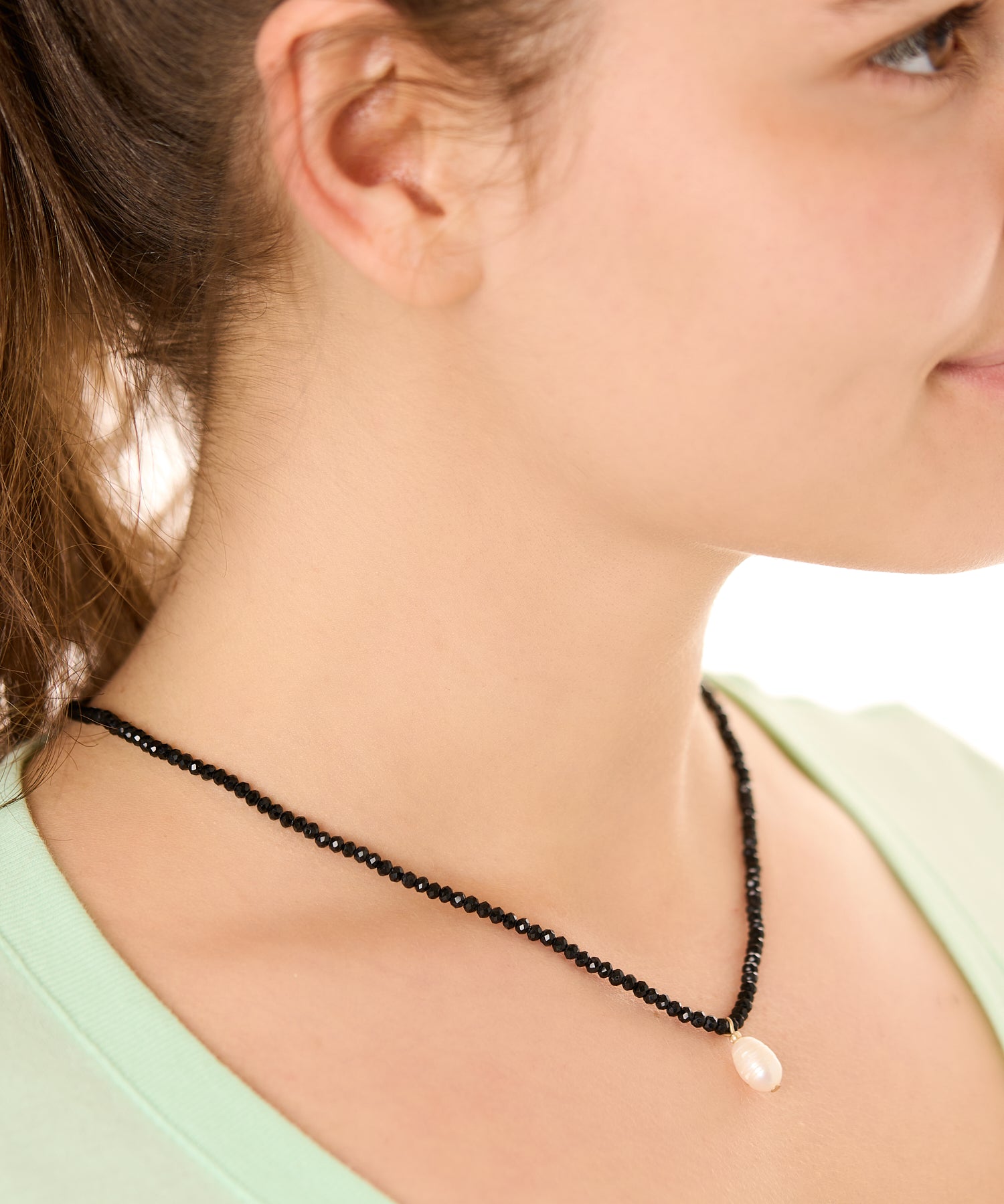 close up view of a female model wearing the black beachcombers necklace