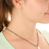 close up view of a female model wearing the gray beachcombers necklace