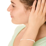 close up view of a female model wearing the White Surf and Sand bracelet