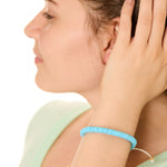 close up view of a female model wearing the blue Bali surf beads bracelet