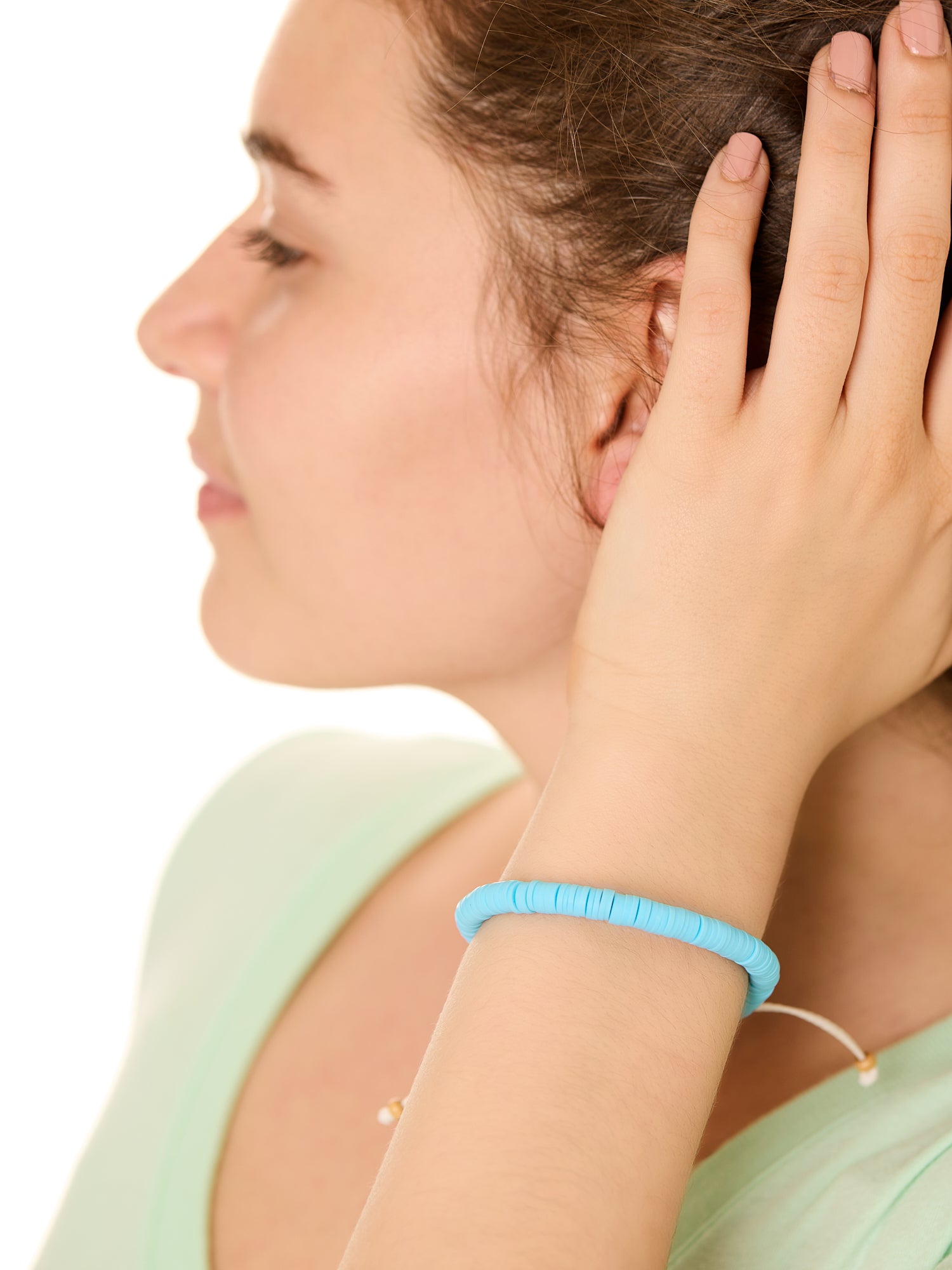 close up view of a female model wearing the blue Bali surf beads bracelet