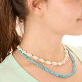 Close-up view of a female model wearing the blue Echoes of Atlantis necklace layered with the turquoise Outer Banks Cowrie necklace.