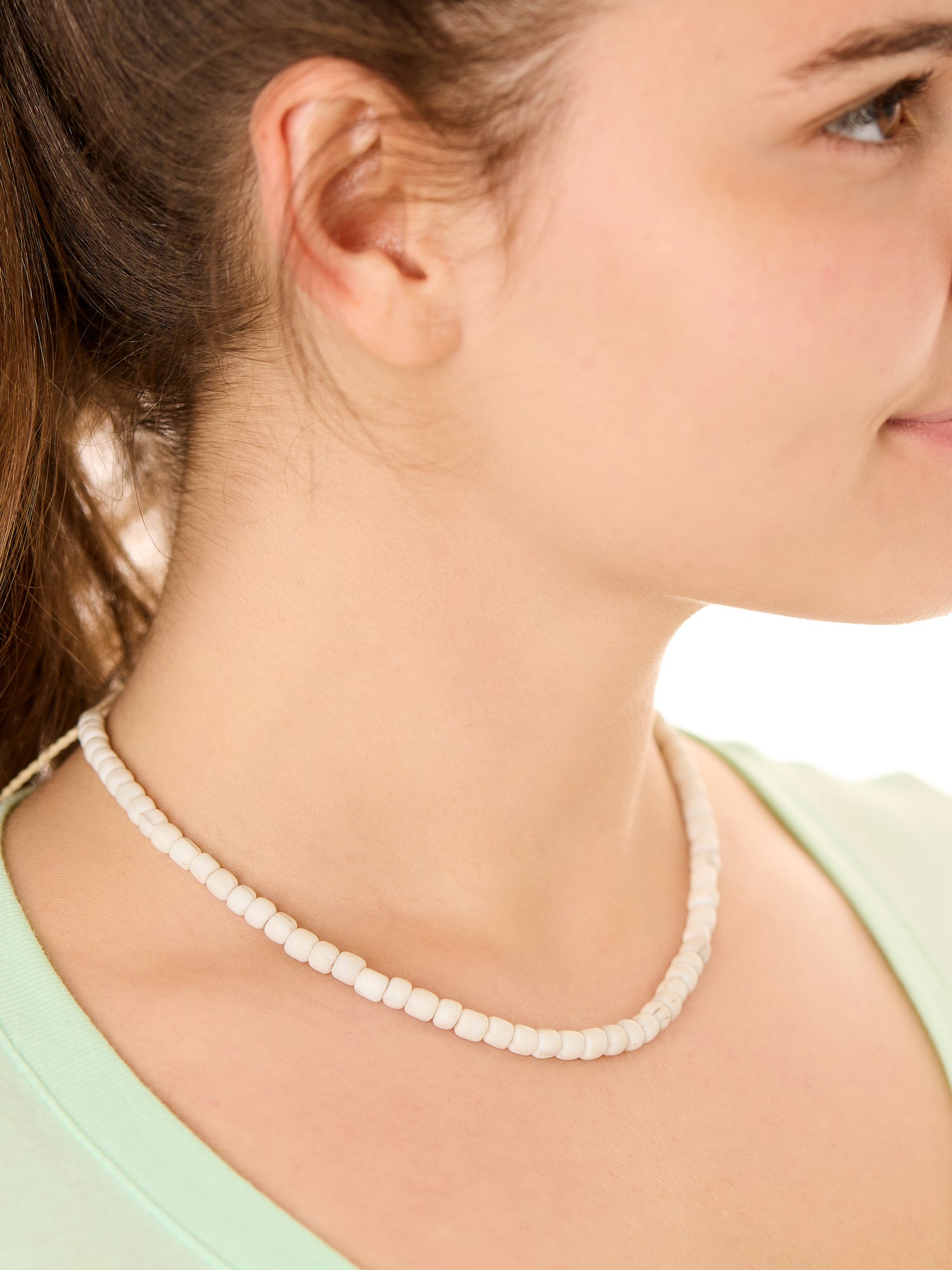 Close-up view of a female model wearing the gray Echoes of Atlantis necklace 