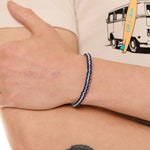 close up view of a male model wearing the surfer knot bracelet 