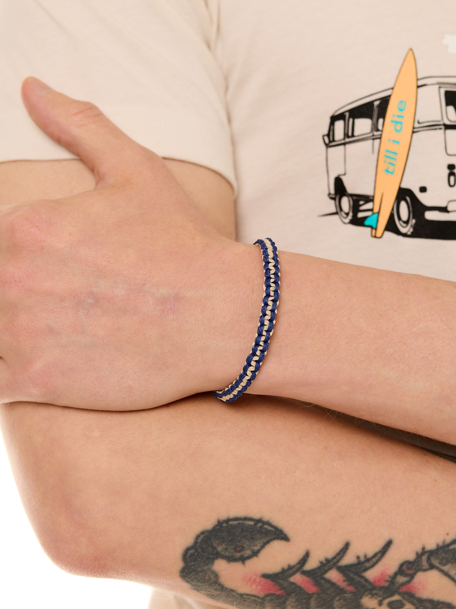 close up view of a male model wearing the surfer knot bracelet 