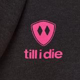 Detail of the hot pink till i die logo on a heather black hoodie