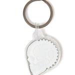 Back view of the Gear Head keychain on a white background, showing a solid white fill and a plastic clip fastener at the top.
