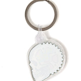 Back view of the Gear Head keychain on a white background, showing a solid white fill and a plastic clip fastener at the top.