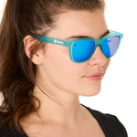 front view of a female model wearing the blue mirage sunglasses on a white background