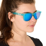 front view of a female model wearing the blue mirage sunglasses on a white background