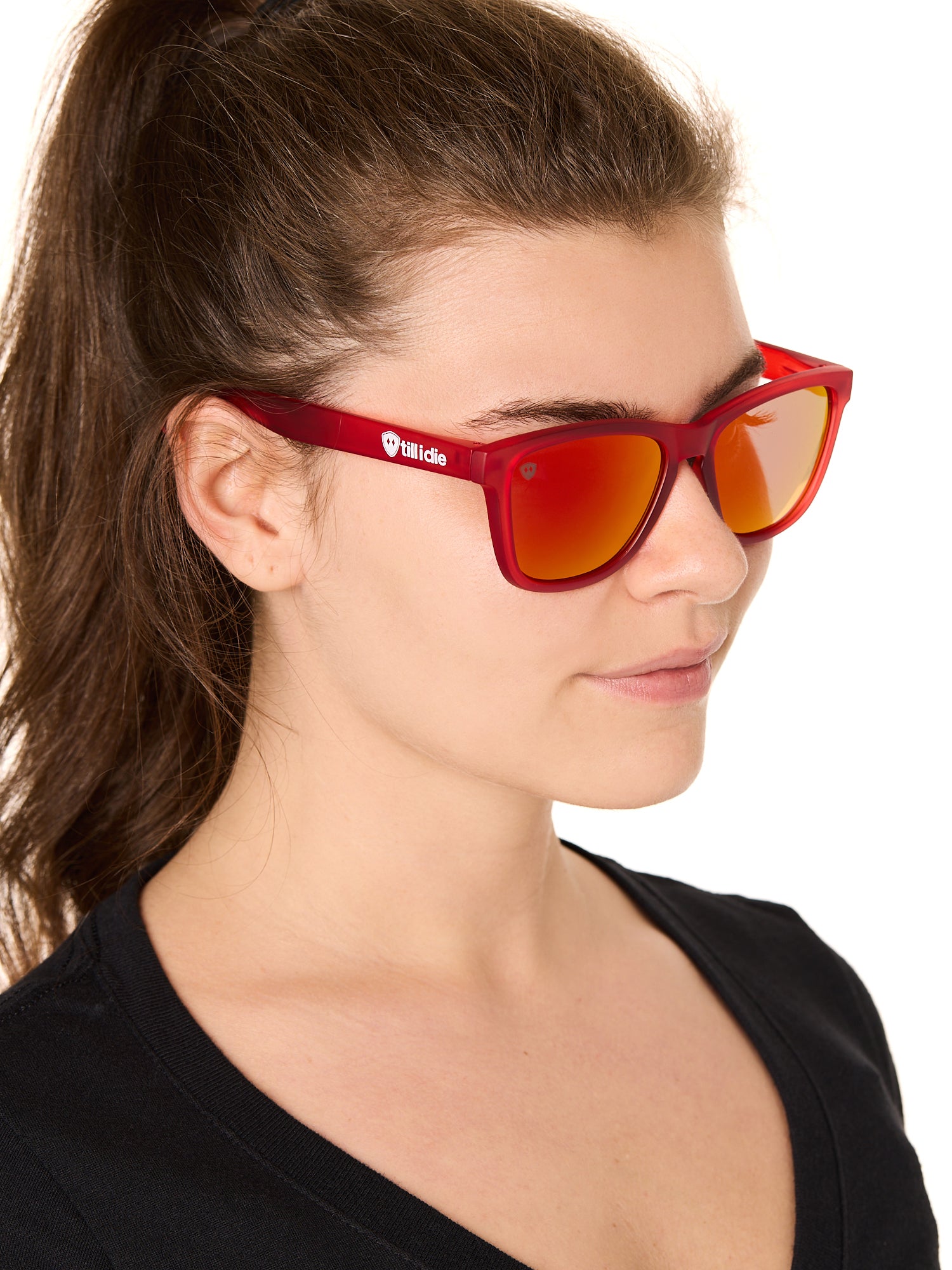 front view of a female model wearing the ruby riptide sunglasses on a white background