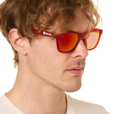 front view of a male model wearing the ruby riptide sunglasses on a white background