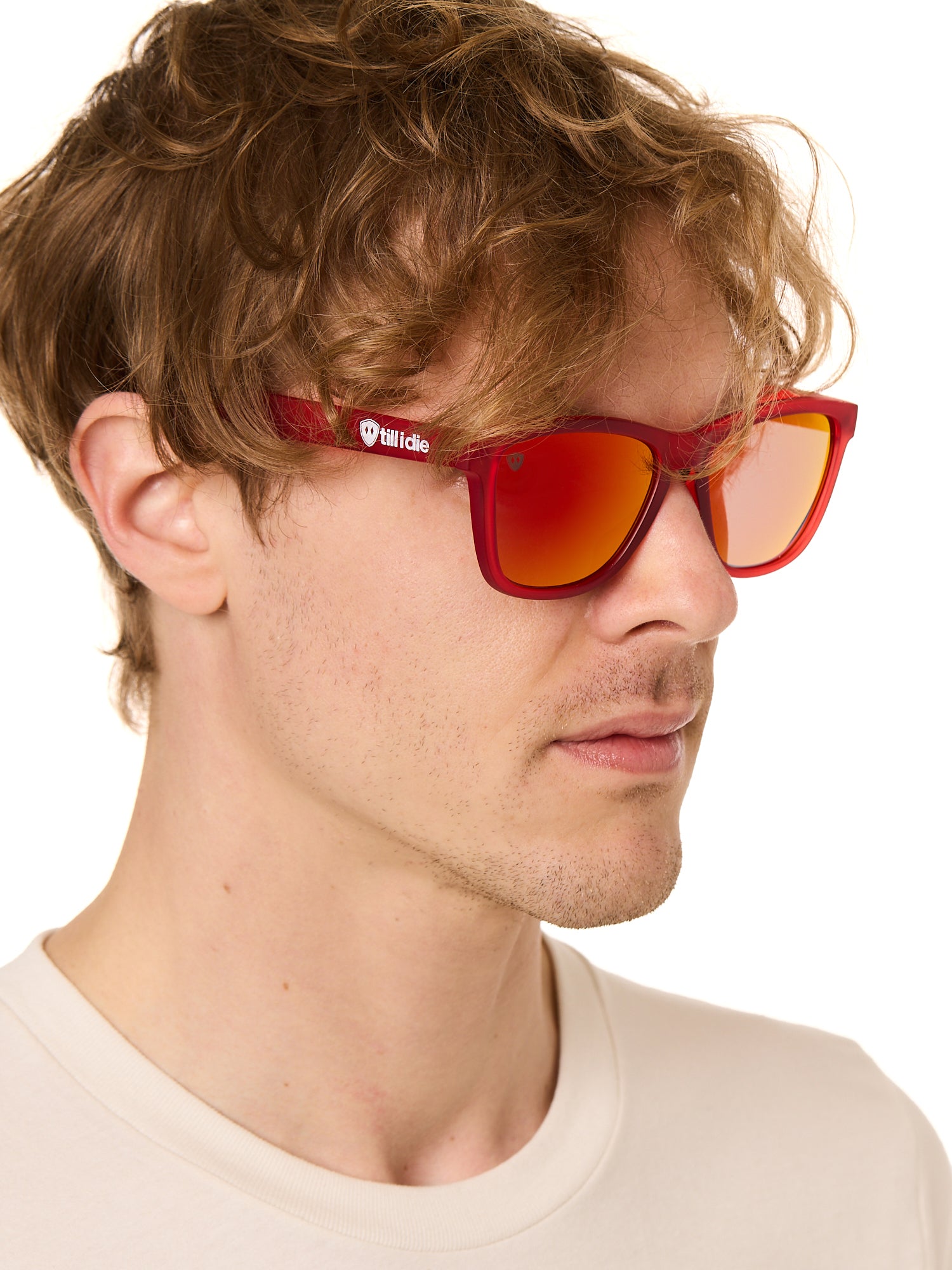 front view of a male model wearing the ruby riptide sunglasses on a white background