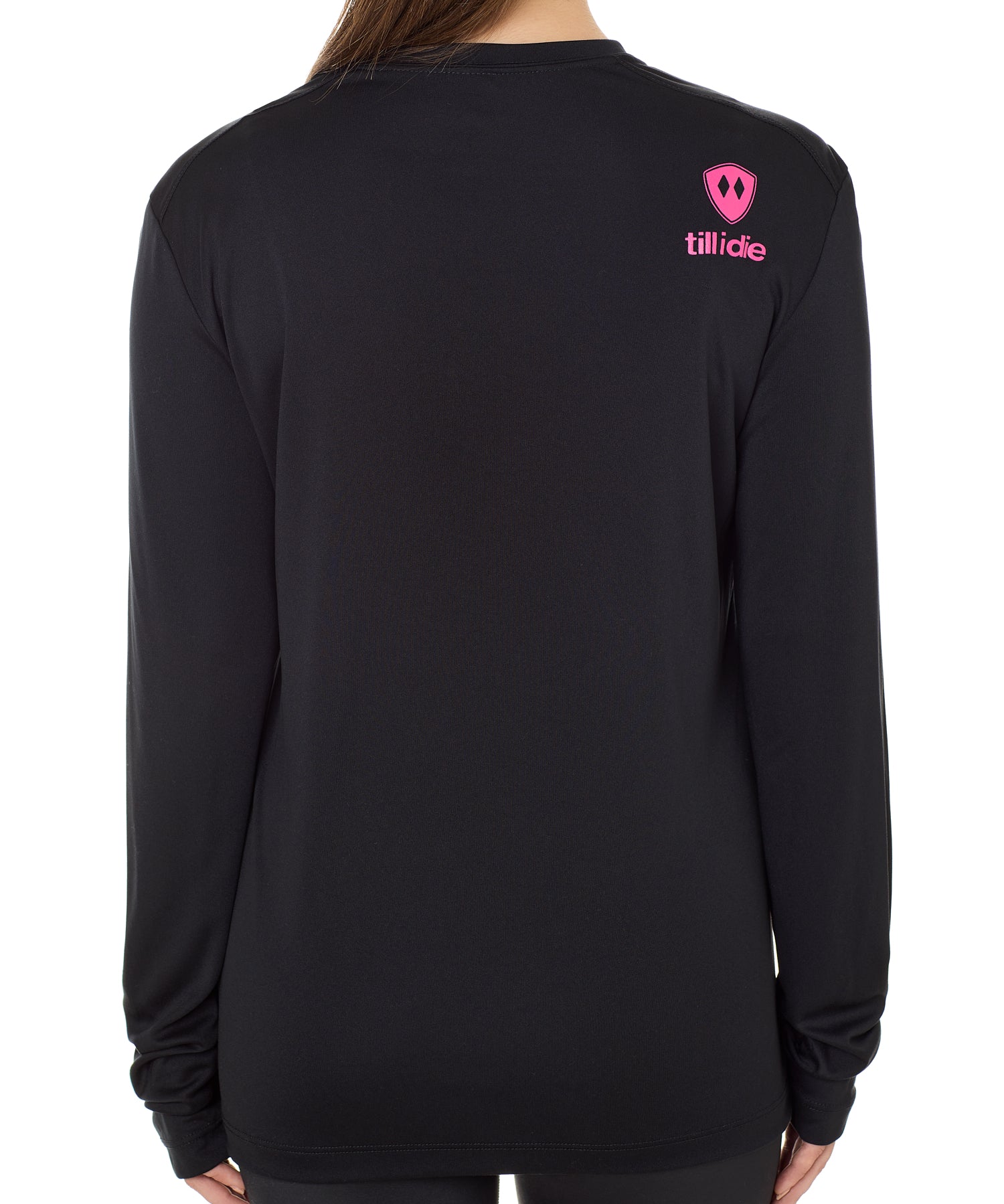 Back view of a female model wearing a black performance long sleeve shirt accented with a hot pink till i die logo on wearers top right shoulder.