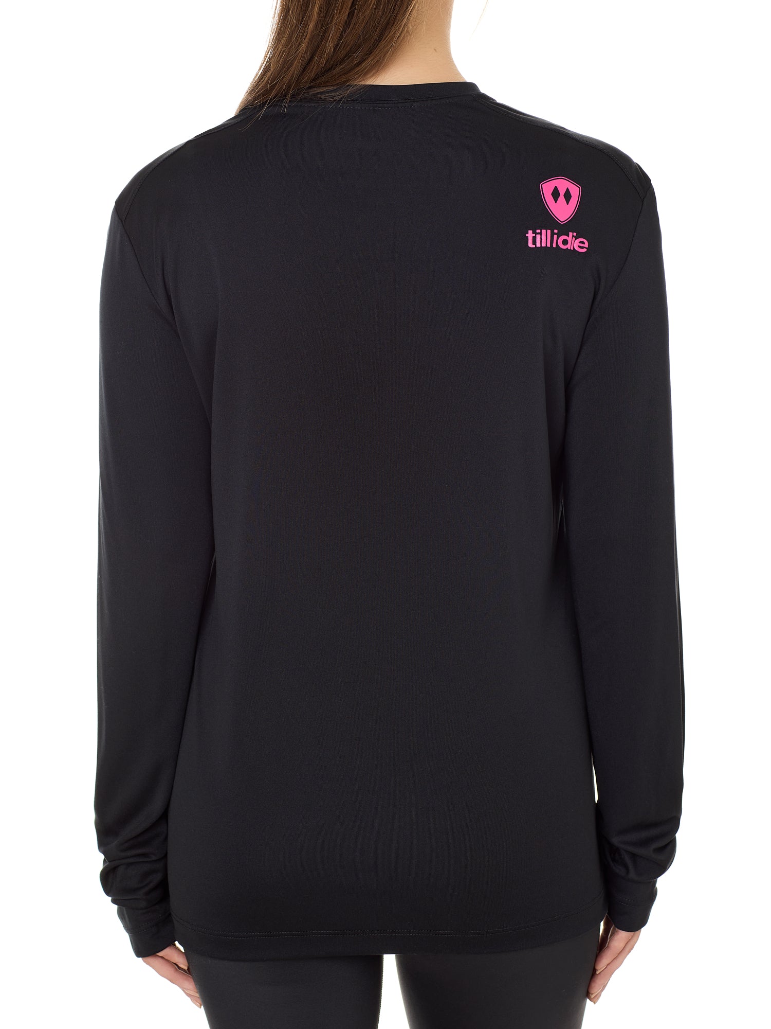 Back view of a female model wearing a black performance long sleeve shirt accented with a hot pink till i die logo on wearers top right shoulder.