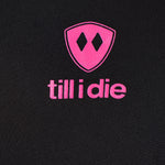 Detail of the hot pink till i die logo on a black performance long sleeve shirt