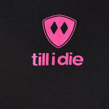 Detail of the hot pink till i die logo on a black performance long sleeve shirt