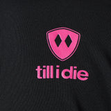 Detail of the hot pink till i die logo on a black performance long sleeve shirt