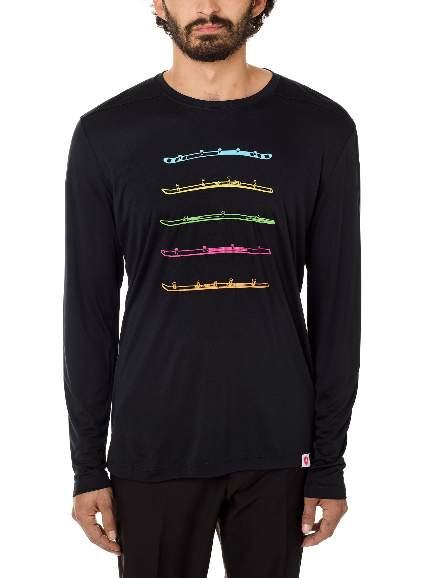 A male model wearing a long sleeve black shirt with bold colorful shot ski graphics.