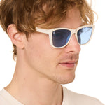 front view of a male model wearing the coastal cloud sunglasses on a white background