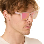 front view of a male model wearing the rosé ripple sunglasses on a white background