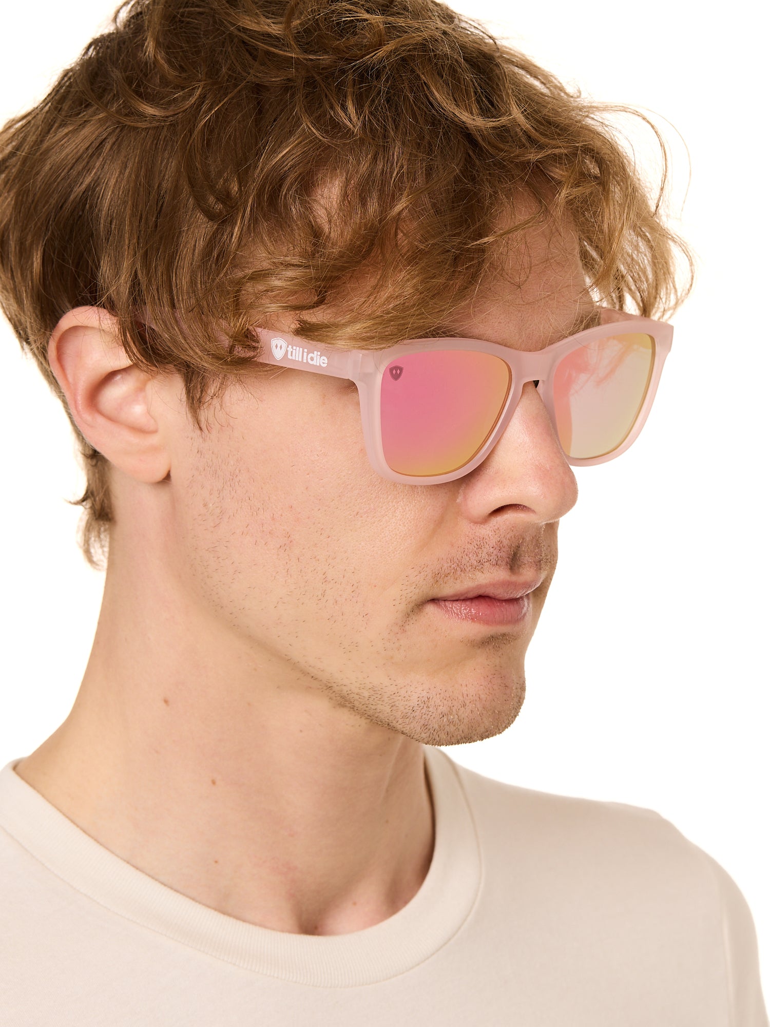 front view of a male model wearing the rosé ripple sunglasses on a white background