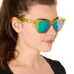 front view of a female model wearing the electric jungle sunglasses on a white background