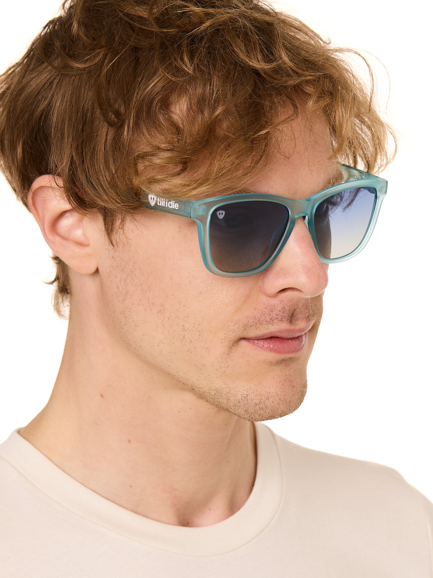 front view of a male model wearing the wave rider sunglasses on a white background