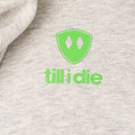 Detail of the Lime Green till i die logo on a heather oatmeal hoodie