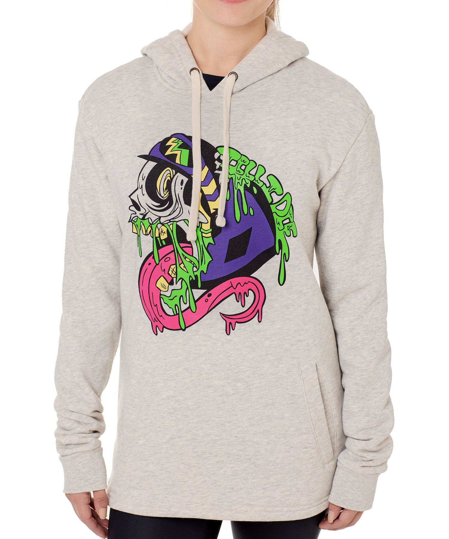 Front view of a female model wearing the Steezy Stan Hoodie in Heather Oatmeal on a white background. The graphic features a multicolored zombie skier with a long tongue, dripping slime, the Double Diamond Shield bursting from its skull, and oozing "Till I Die" text in a sludge-like style.