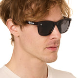 front view of a male model wearing the smoke and mirrors sunglasses on a white background