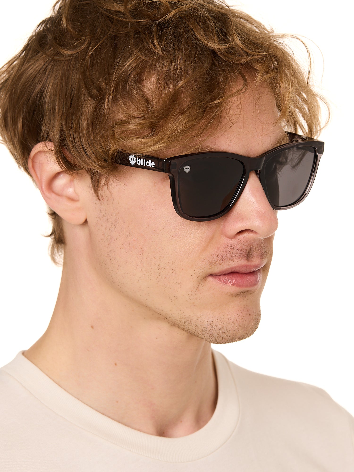 front view of a male model wearing the smoke and mirrors sunglasses on a white background