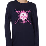Front view of a female model wearing the ULLR navy crew neck long sleeve tee on a white background. The pink and white graphic features a skull over crossed skis, with snowflakes, pine trees, and “Till I Die” text layered below.