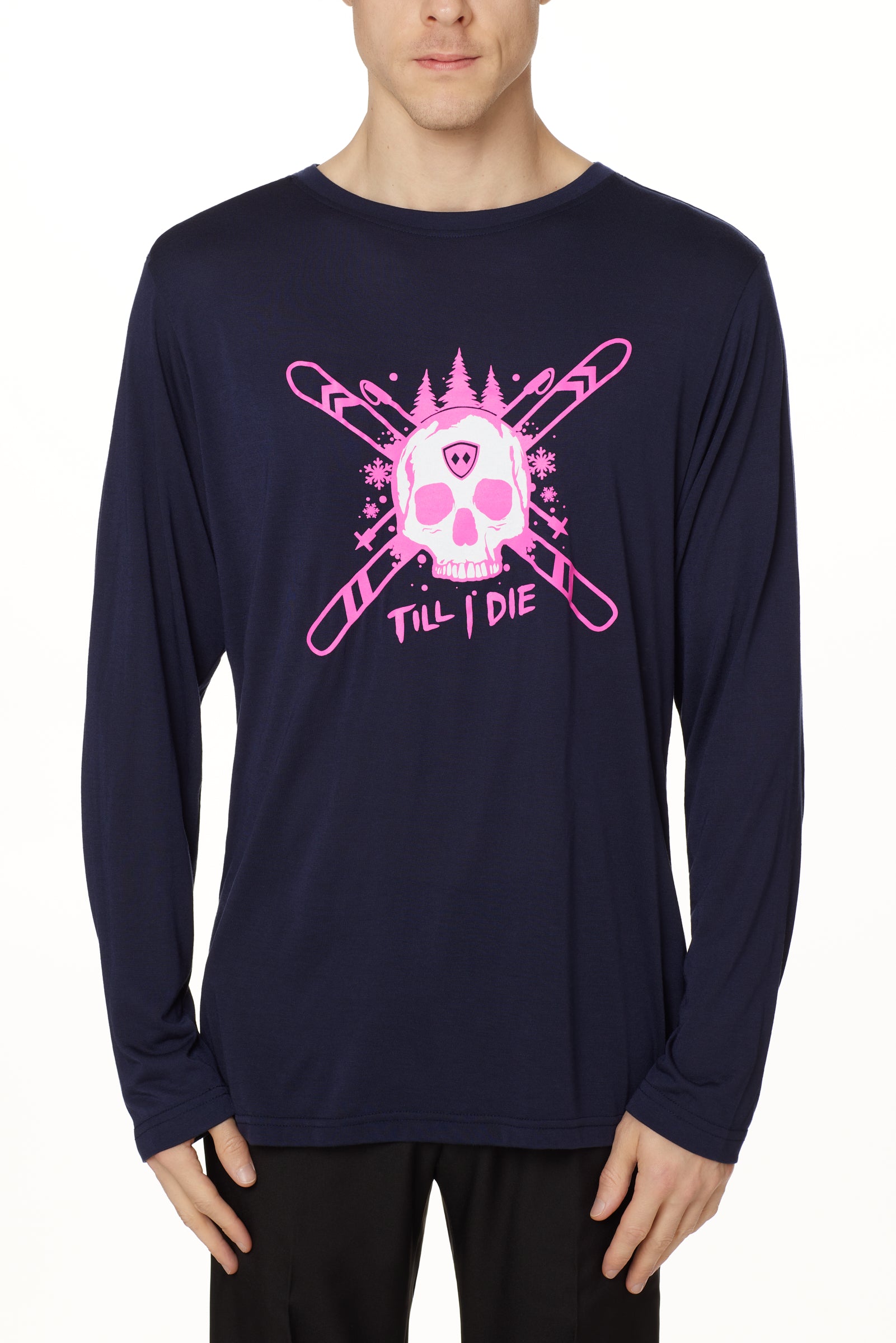 Front view of a male model wearing the ULLR navy crew neck long sleeve tee on a white background. The pink and white graphic features a skull over crossed skis, with snowflakes, pine trees, and “Till I Die” text layered below.