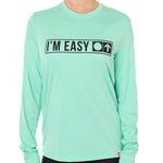 A female model wearing a MINT green long sleeve performance shirt with the text 'I'm Easy' IN A TRAIL SIGN DESIGN printed on the front.