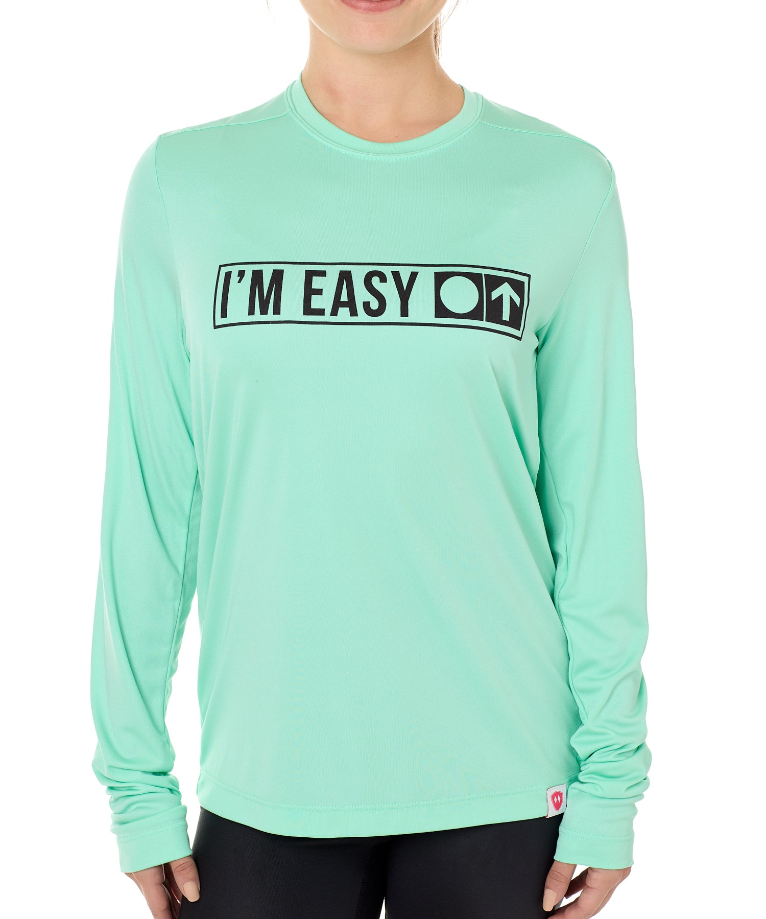 A female model wearing a MINT green long sleeve performance shirt with the text 'I'm Easy' IN A TRAIL SIGN DESIGN printed on the front.