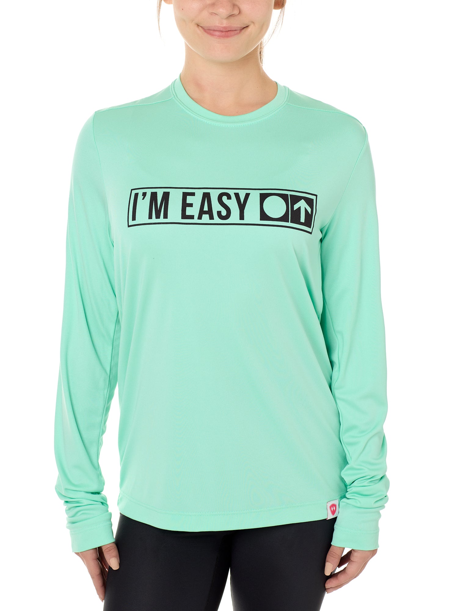 A female model wearing a MINT green long sleeve performance shirt with the text 'I'm Easy' IN A TRAIL SIGN DESIGN printed on the front.