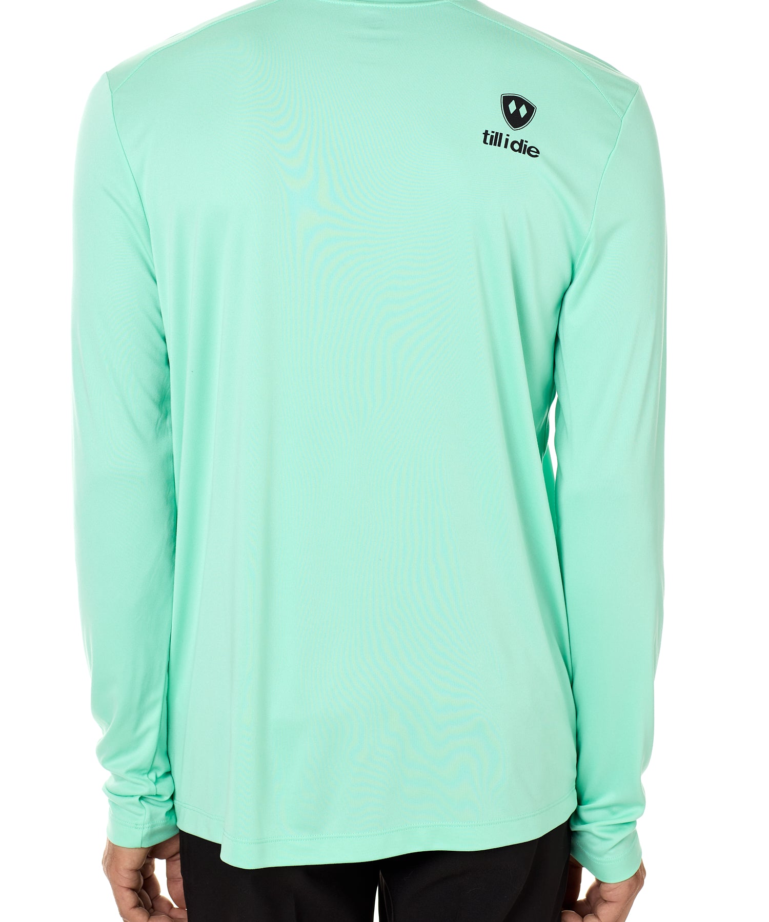 Back view of a male model wearing a mint green performance long sleeve shirt on a white background, featuring a black Till I Die logo on the wearer’s top right shoulder.