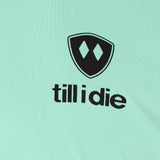 Detail of the black till i die logo on a mint green performance long sleeve shirt