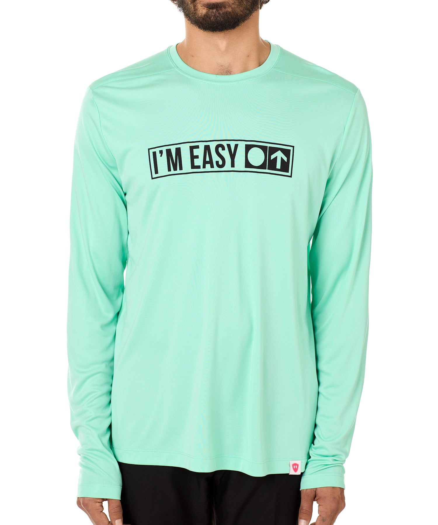 Front view of a male model wearing the "I'm Easy" Mint Green Long Sleeve Performance Shirt. The graphic features trail sign-inspired "I'm Easy" text with a circle symbol indicating beginner terrain.