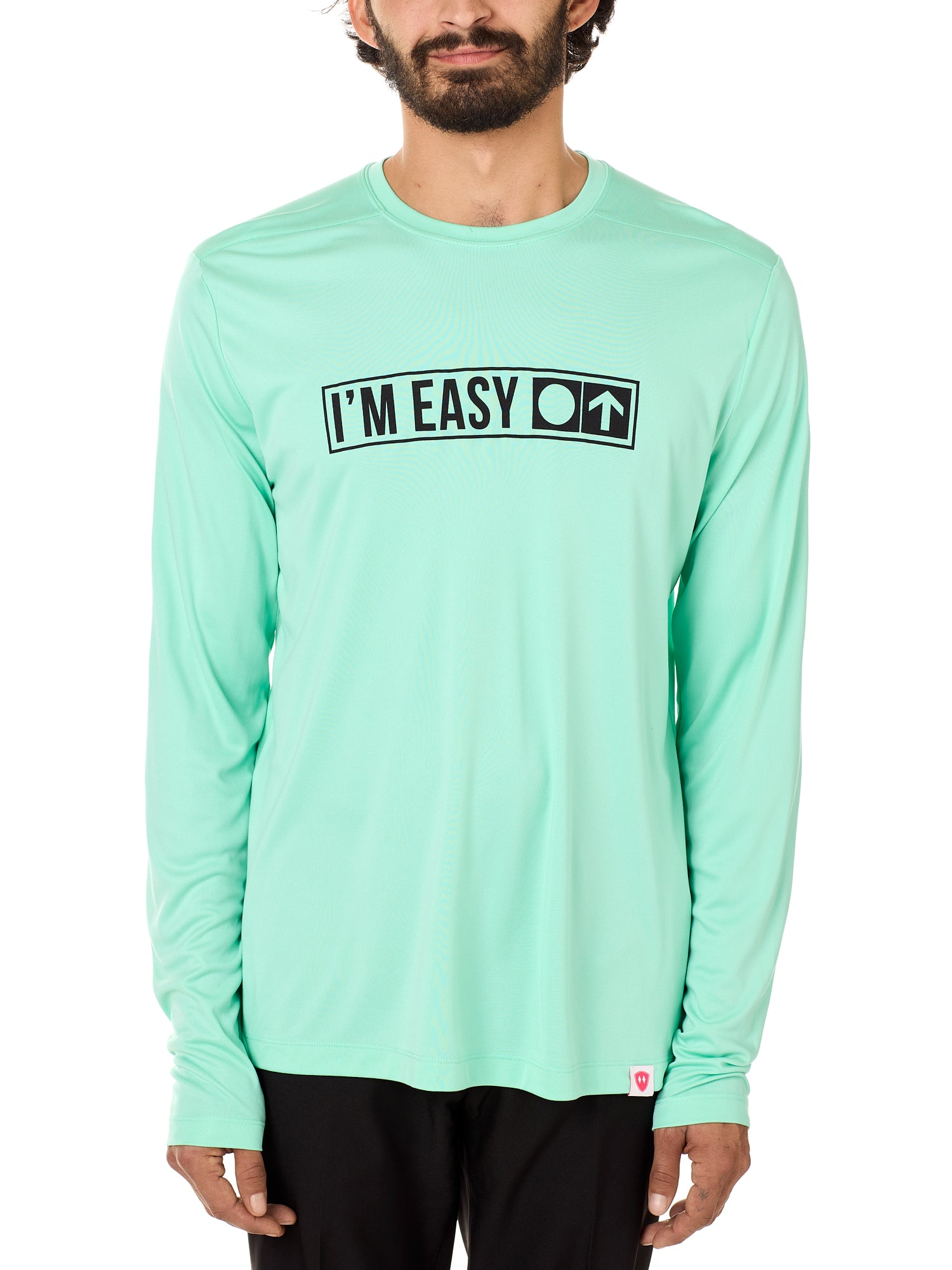 Front view of a male model wearing the "I'm Easy" Mint Green Long Sleeve Performance Shirt. The graphic features trail sign-inspired "I'm Easy" text with a circle symbol indicating beginner terrain.