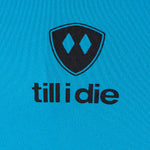 Detail of the black till i die logo on a Sapphire blue performance long sleeve shirt