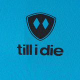 Detail of the black till i die logo on a Sapphire blue performance long sleeve shirt