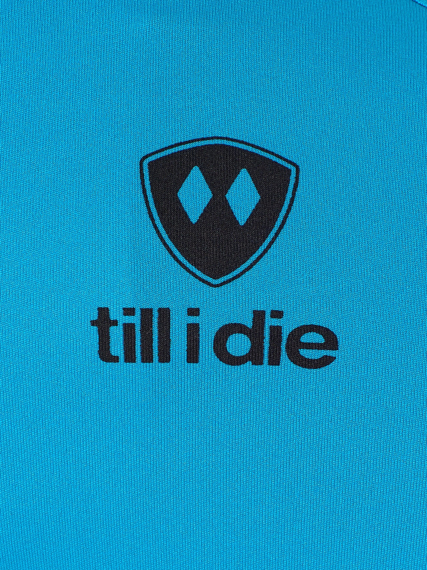 Detail of the black till i die logo on a Sapphire blue performance long sleeve shirt