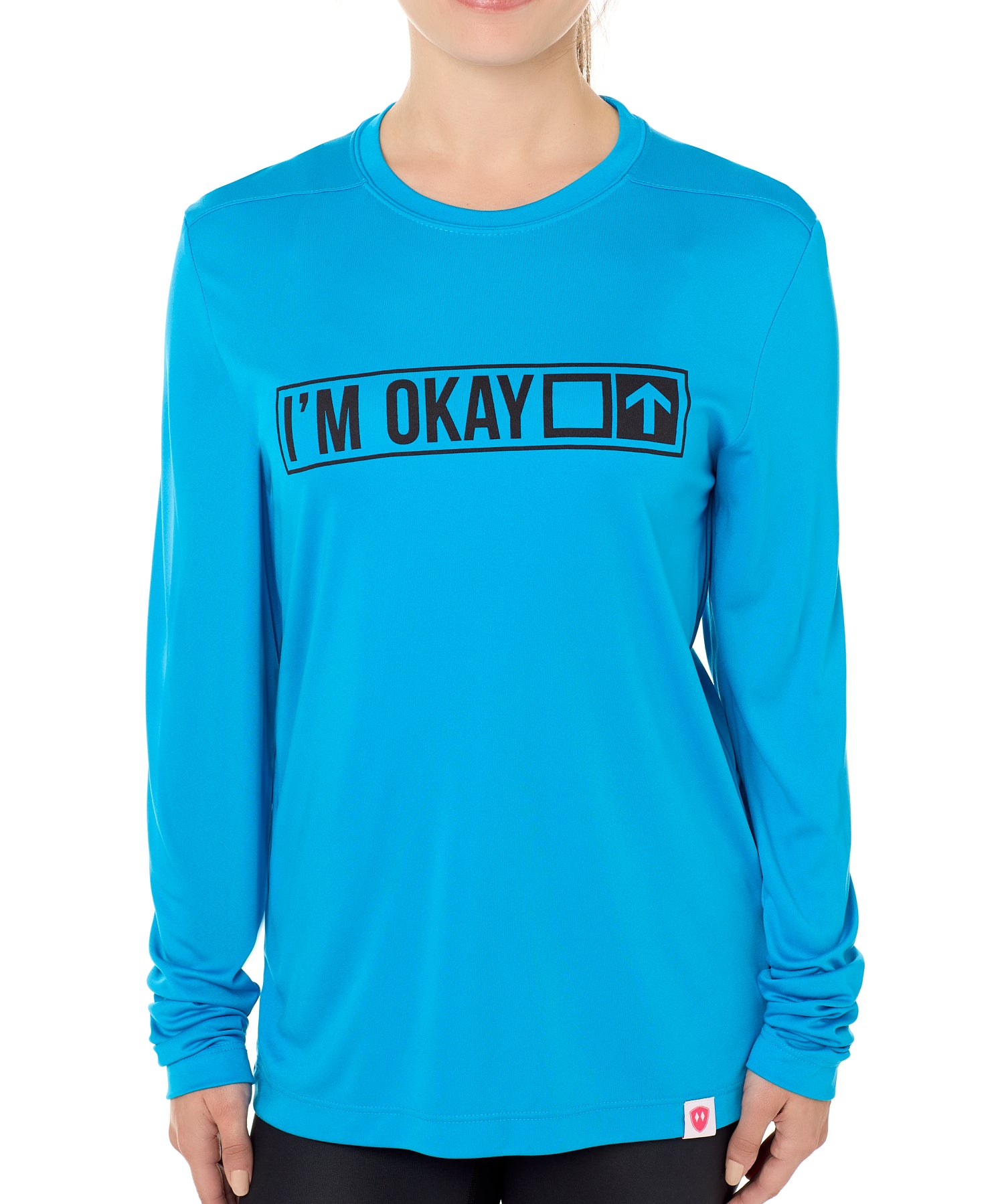 A female model wearing a blue long sleeve T-shirt with the text 'I'm Okay' IN A TRAIL SIGN DESIGN printed on the front.