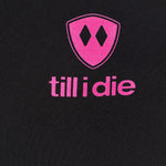 Detail of the hot pink till i die logo on a black performance long sleeve shirt