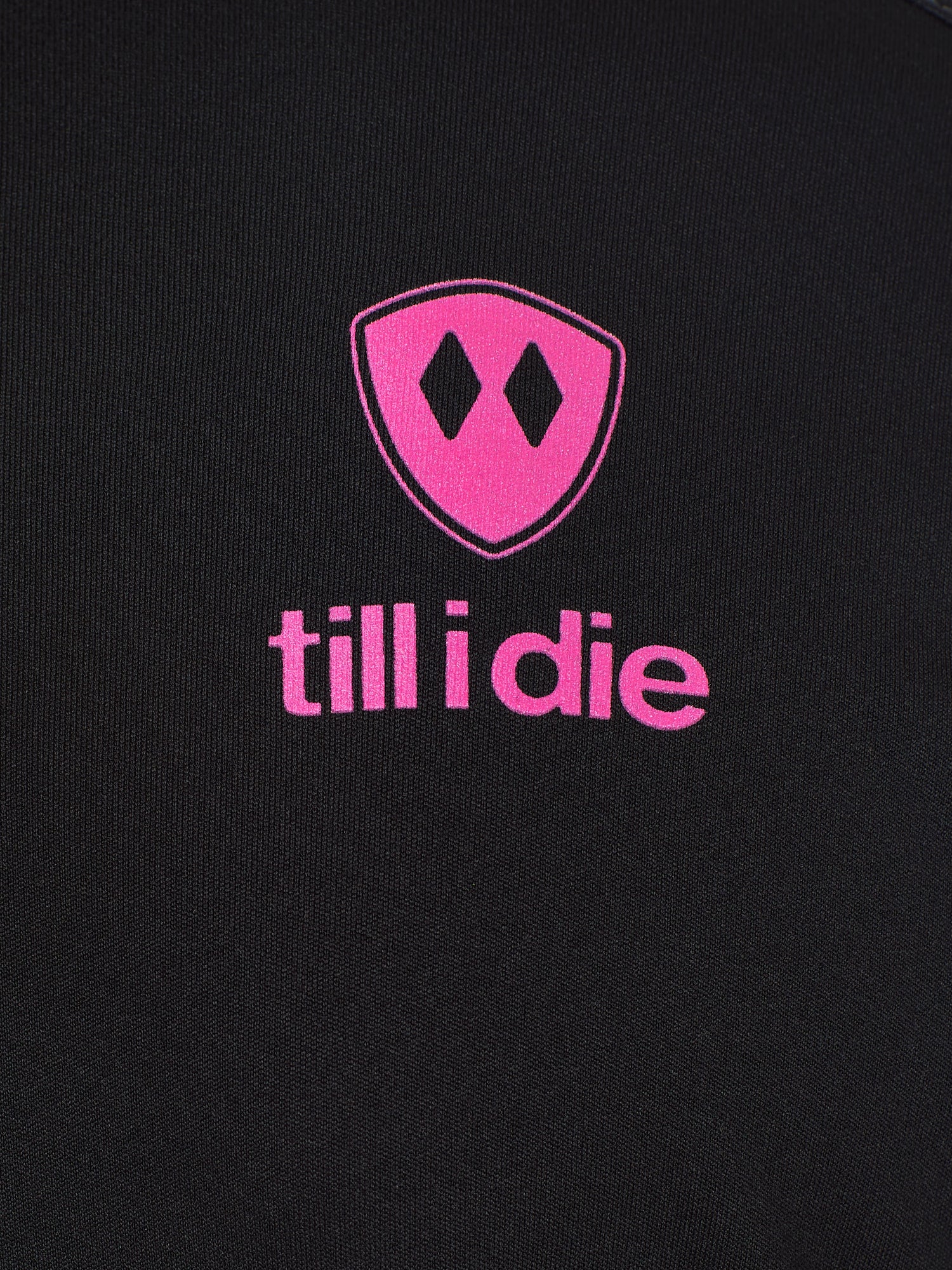 Detail of the hot pink till i die logo on a black performance long sleeve shirt