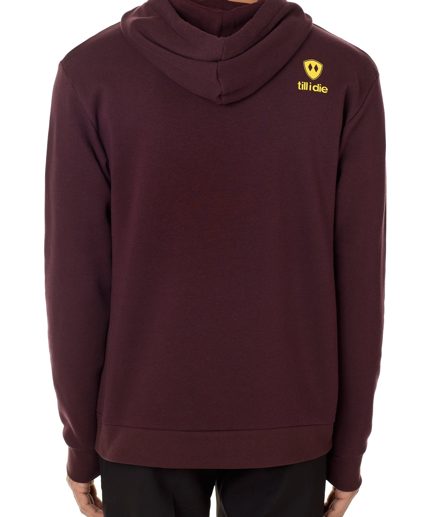 Back view of a male model wearing an oxblood hoodie accented with a yellow till i die logo on wearers top right shoulder.
