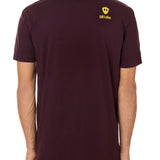 Back view of a male model wearing an oxblood tee shirt accented with a yellow till i die logo on wearers top right shoulder.